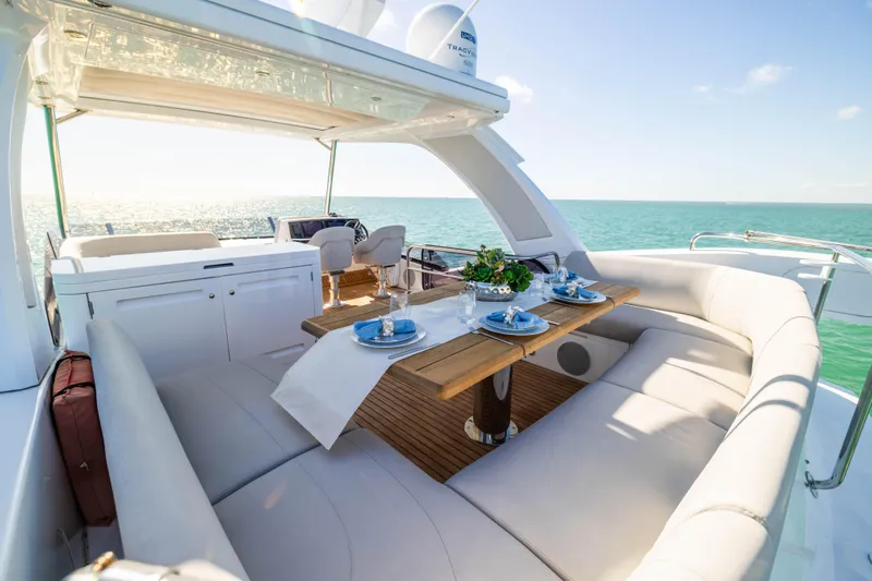 Dreams Yacht Photos Pics Luxurious Sunseeker Manhattan 55 yacht deck with elegant dining setup, 2021 model.