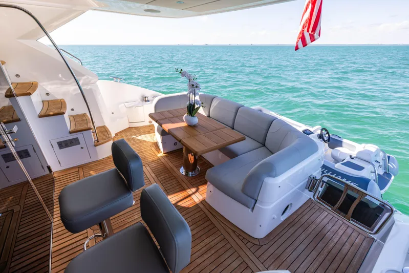 Dreams Yacht Photos Pics Luxurious Sunseeker Manhattan 55 yacht deck with seating, table, and ocean view, 2021 model.