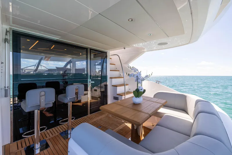Dreams Yacht Photos Pics Luxurious Sunseeker Manhattan 55 yacht deck with seating, table, and ocean view, 2021 model.
