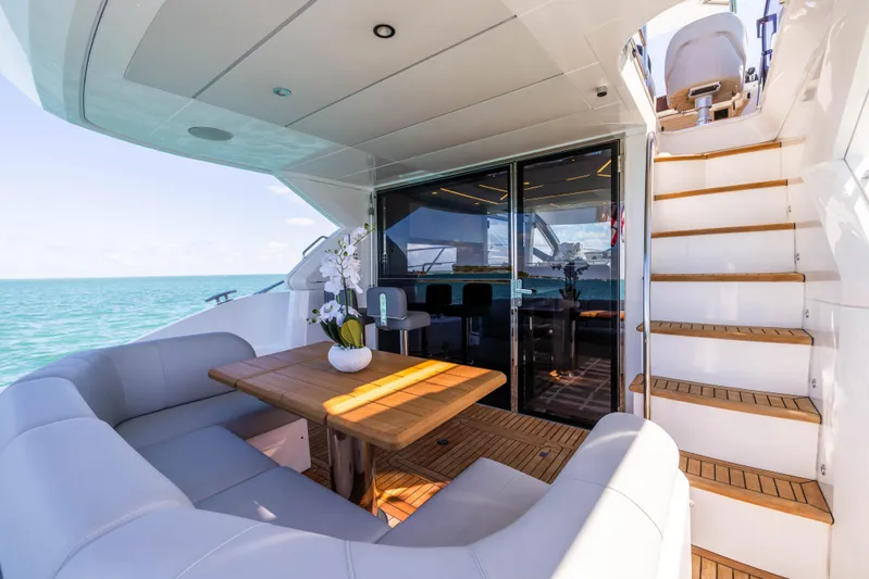 Dreams Yacht Photos Pics Luxurious Sunseeker Manhattan 55 yacht deck with seating, table, and ocean view, 2021 model.