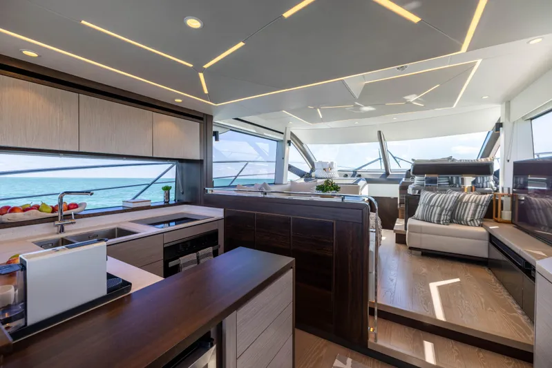Dreams Yacht Photos Pics Luxurious interior of 2021 Sunseeker Manhattan 55 yacht with modern kitchen and seating area.