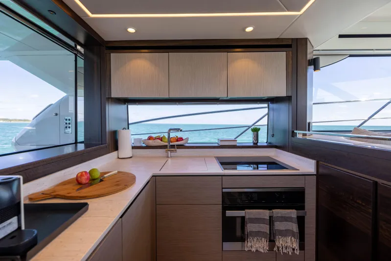 Dreams Yacht Photos Pics Luxurious kitchen interior of 2021 Sunseeker Manhattan 55 yacht with modern appliances and ocean view.
