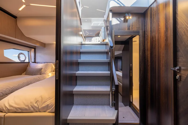 Dreams Yacht Photos Pics Luxurious interior of 2021 Sunseeker Manhattan 55 yacht with elegant staircase and cozy bedroom.