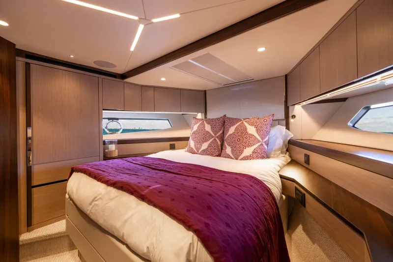Dreams Yacht Photos Pics Luxurious bedroom interior of 2021 Sunseeker Manhattan 55 yacht with elegant bedding and wood finishes.