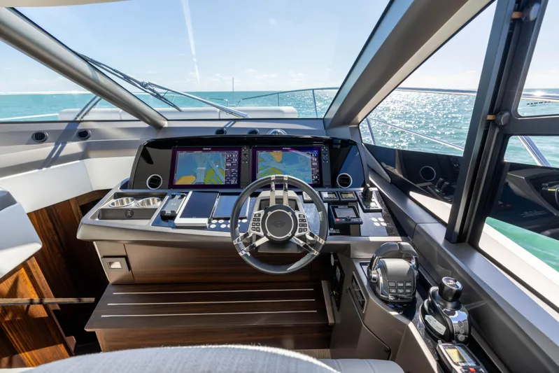 Dreams Yacht Photos Pics 2021 Sunseeker Manhattan 55 yacht cockpit with modern navigation systems and ocean view.