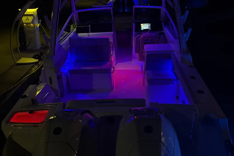  Yacht Photos Pics 2025 Boston Whaler 280 Vantage boat interior with vibrant blue and red lighting.