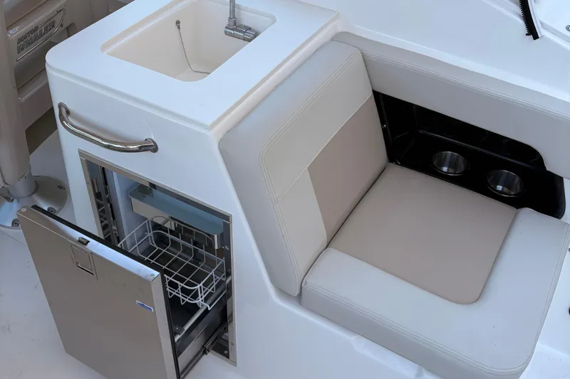  Yacht Photos Pics 2025 Boston Whaler 280 Vantage interior with sink, seating, and storage.