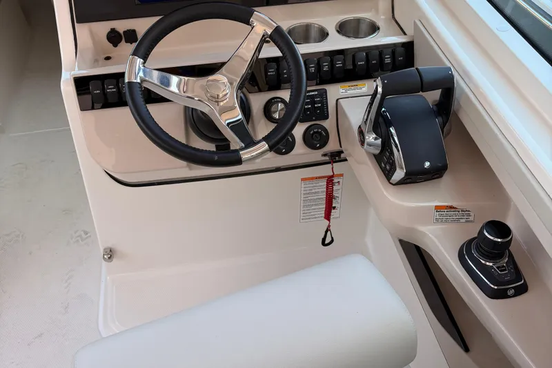  Yacht Photos Pics 2025 Boston Whaler 280 Vantage helm with steering wheel and controls.