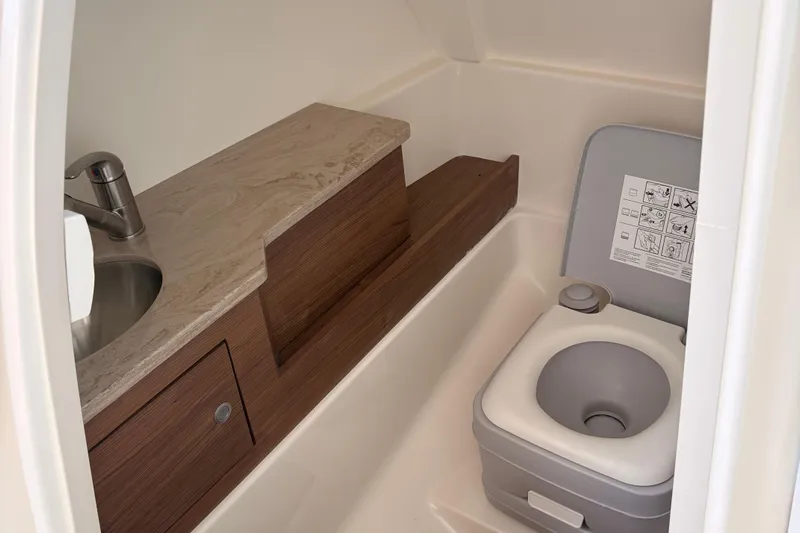  Yacht Photos Pics 2025 Boston Whaler 280 Vantage boat bathroom with sink and portable toilet.