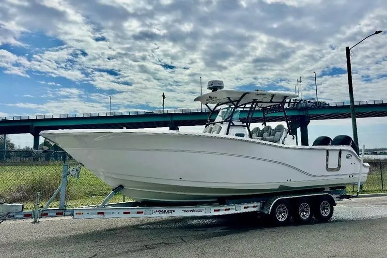  Yacht Photos Pics 2023 Sea Fox 328 Commander boat on trailer under cloudy sky.