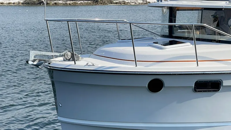  Yacht Photos Pics 2025 Ranger Tugs R-25 boat on water, showcasing sleek design and modern features.