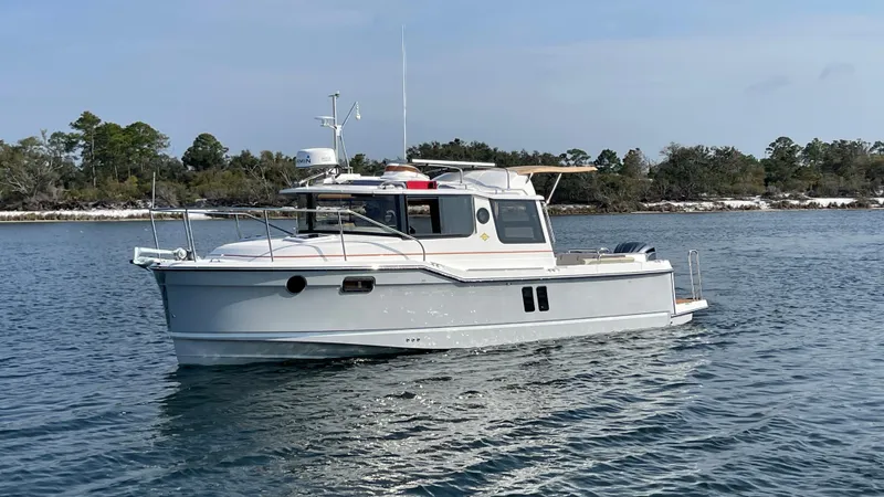  Yacht Photos Pics 2025 Ranger Tugs R-25 boat cruising on a calm lake.