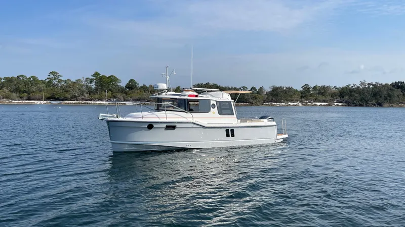  Yacht Photos Pics 2025 Ranger Tugs R-25 boat on calm water, scenic background.