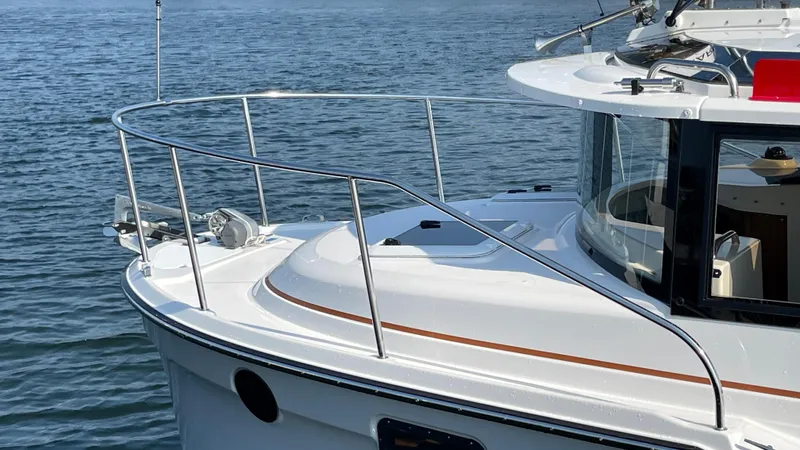 Yacht Photos Pics 2025 Ranger Tugs R-25 boat on water, showcasing sleek design and railing.
