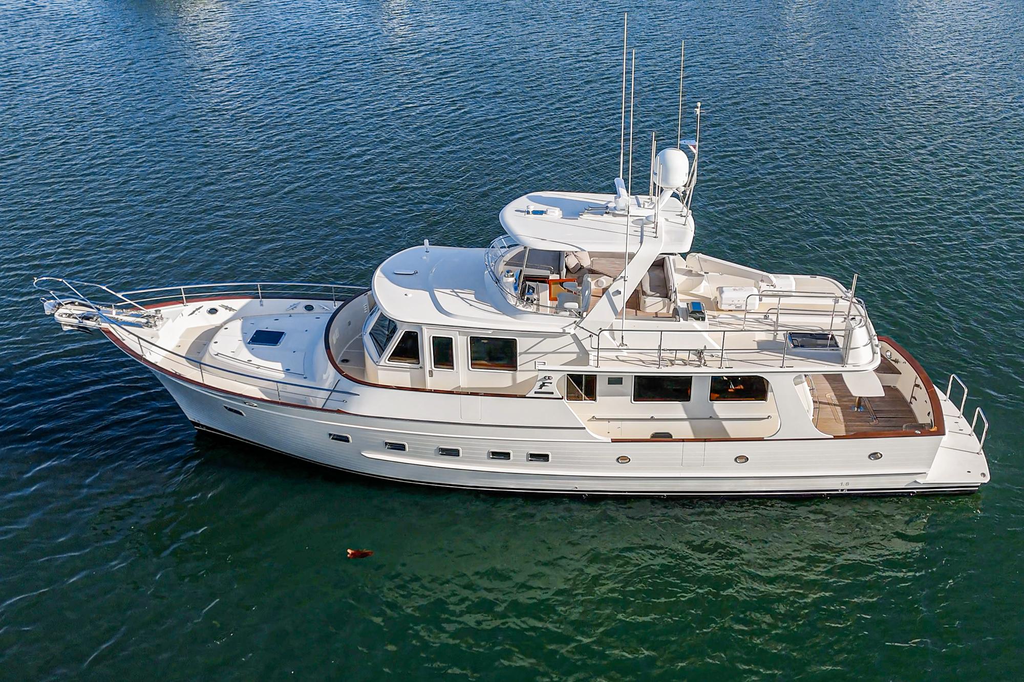 2018 Fleming 58 Pilothouse yacht on calm water, aerial view.