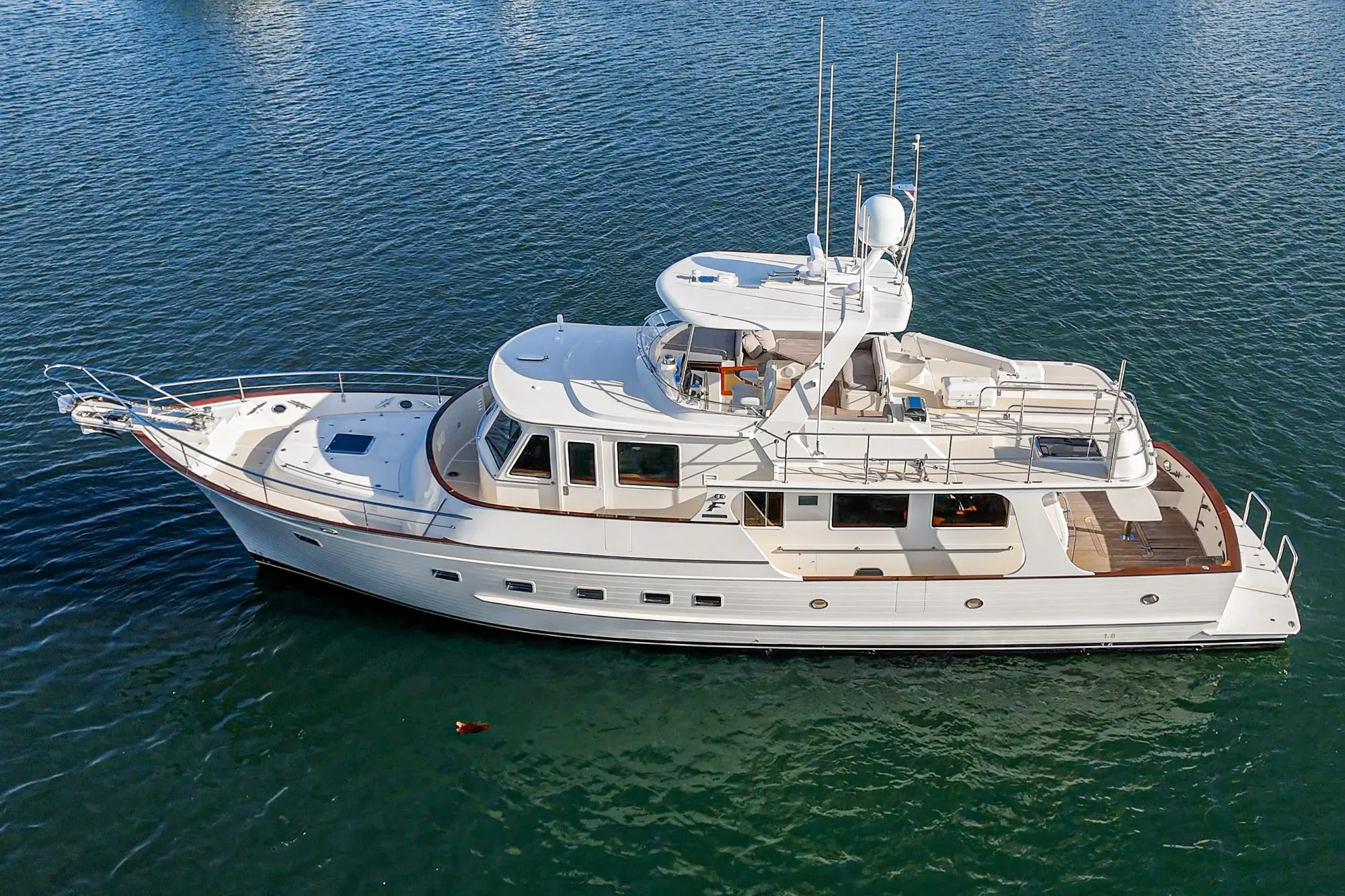 2018 Fleming 58 Pilothouse yacht on calm water, aerial view.