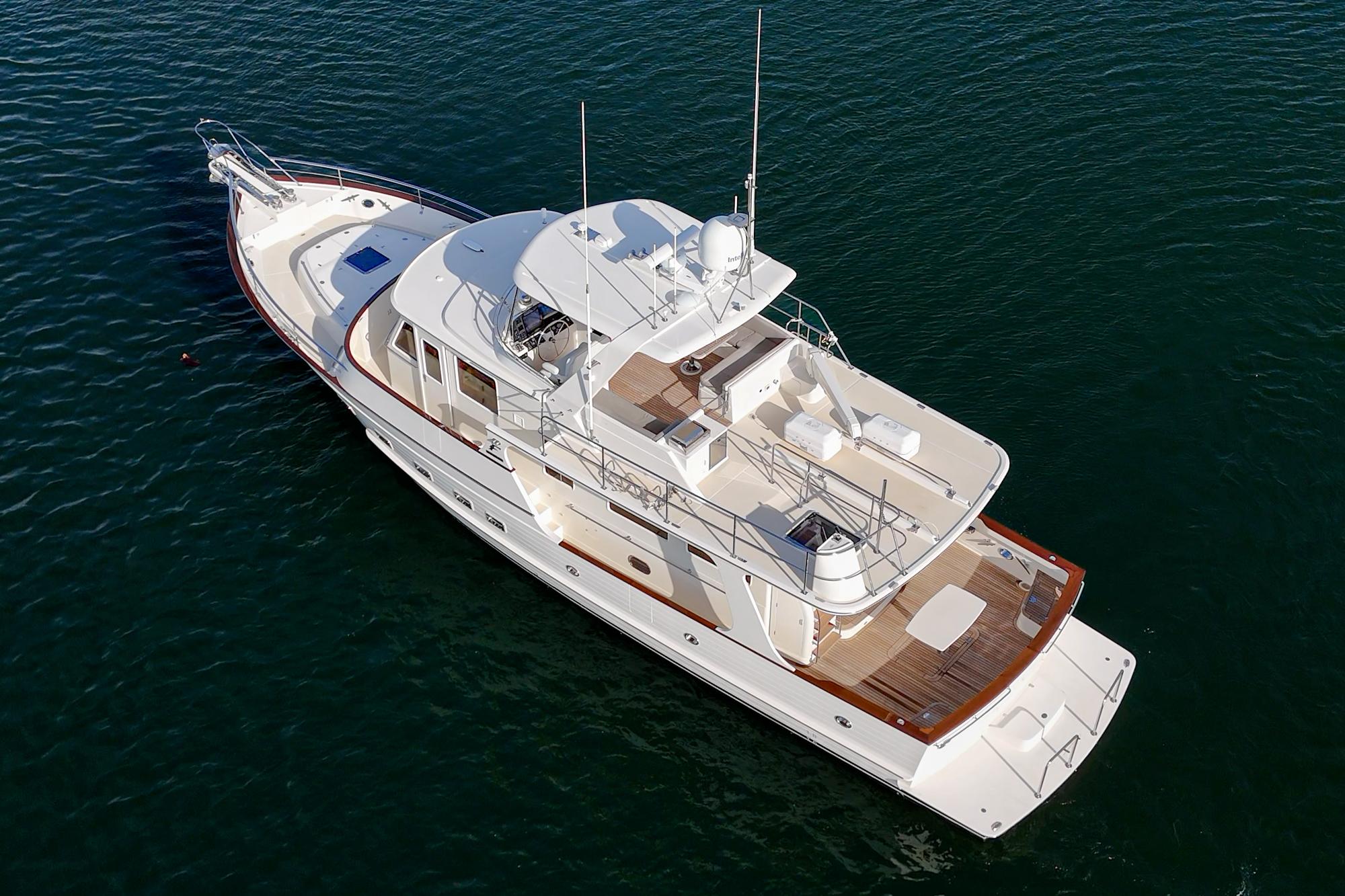 2018 Fleming 58 Pilothouse yacht on calm water, aerial view.