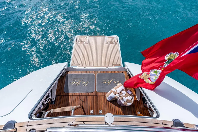 La Joie De Mer Yacht Photos Pics Luxury Jongert 2900M yacht deck with flag, 2005 model, on clear blue water.