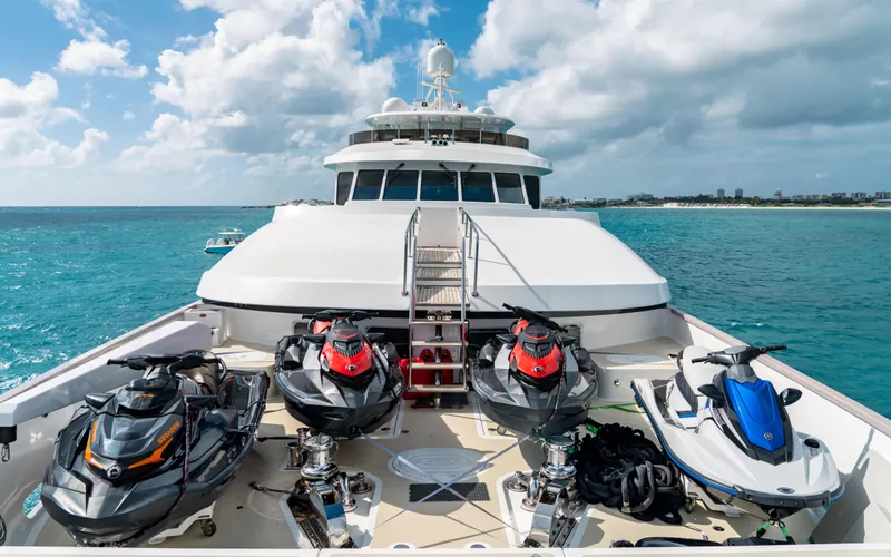 Sea Class Yacht Photos Pics Luxurious 1997 Christensen yacht with jet skis on deck, cruising in clear blue waters.