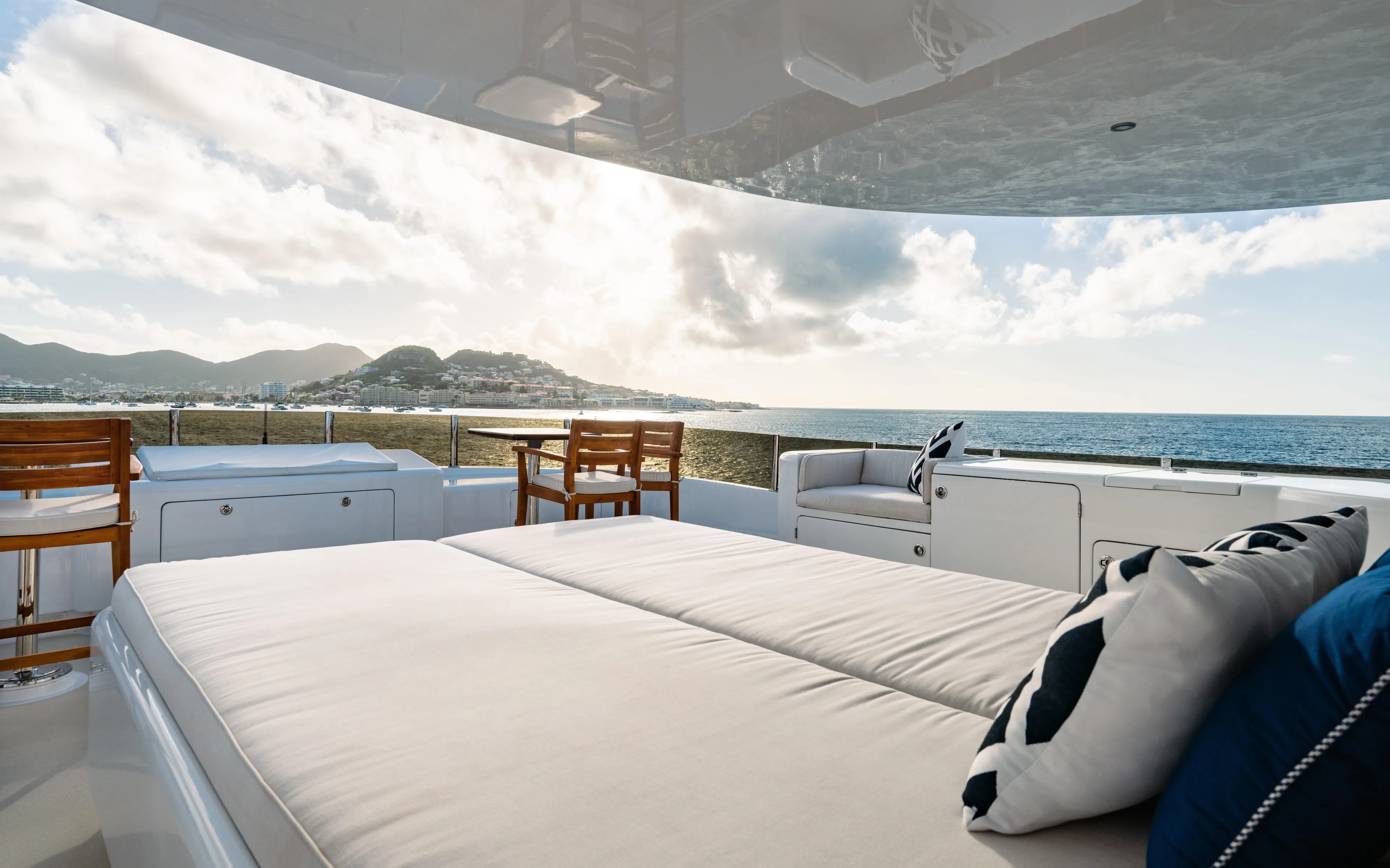 Sea Class Yacht Photos Pics Luxurious 1997 Christensen yacht deck with seating, ocean view, and mountains in the background.