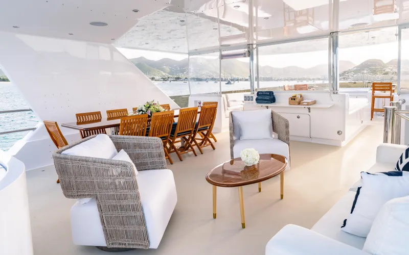 Sea Class Yacht Photos Pics Luxurious 1997 Christensen yacht deck with elegant seating and dining area, overlooking scenic waters.
