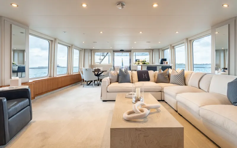 Sea Class Yacht Photos Pics Luxurious yacht interior with spacious seating, large windows, and elegant decor, Christensen 1997 model.