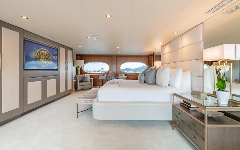 Sea Class Yacht Photos Pics Luxurious yacht bedroom interior with modern decor, large bed, and elegant furnishings, Christensen 1997 model.