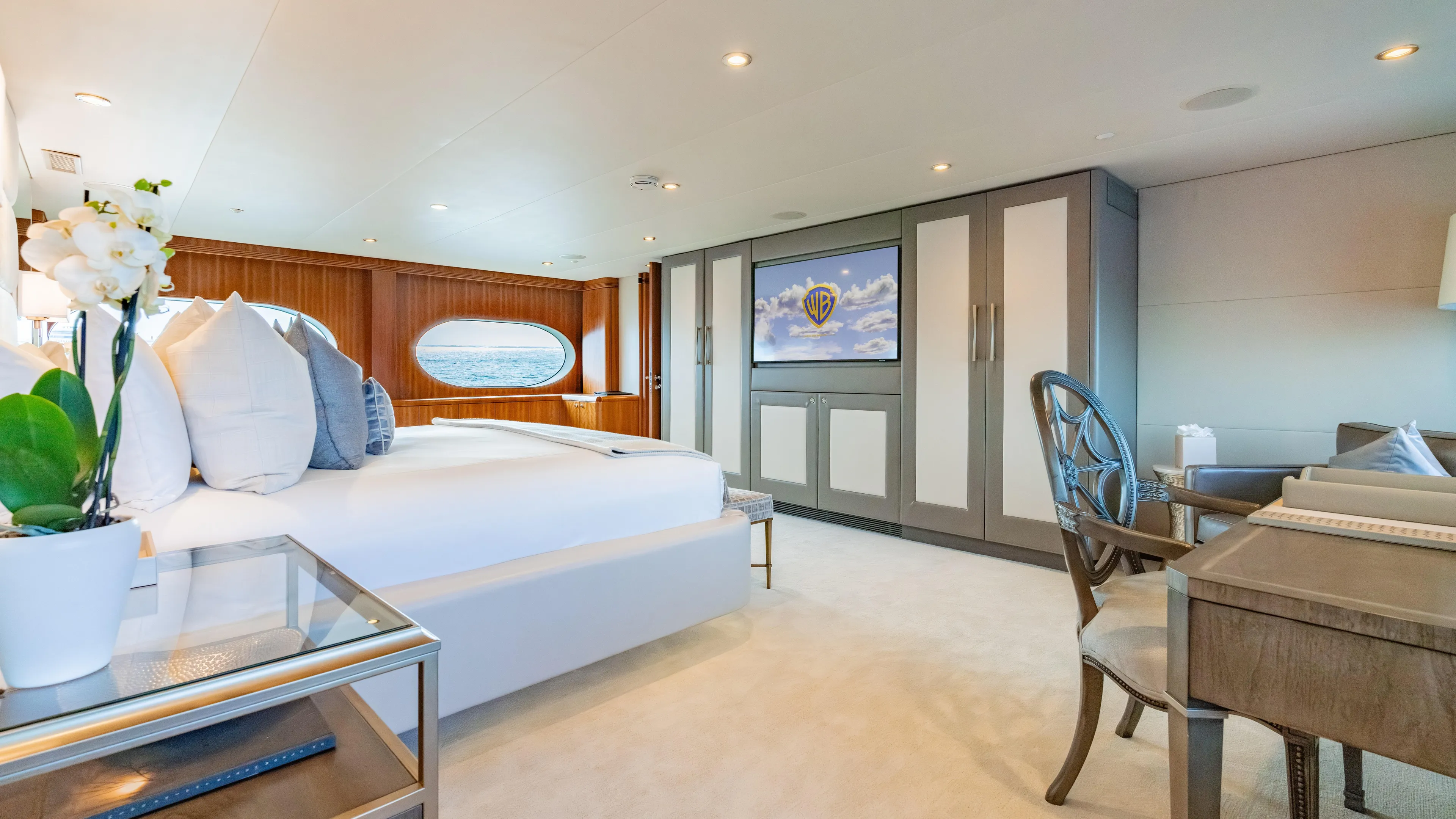 Sea Class Yacht Photos Pics Luxurious yacht bedroom with elegant decor, large bed, and ocean view, Christensen 1997 model.