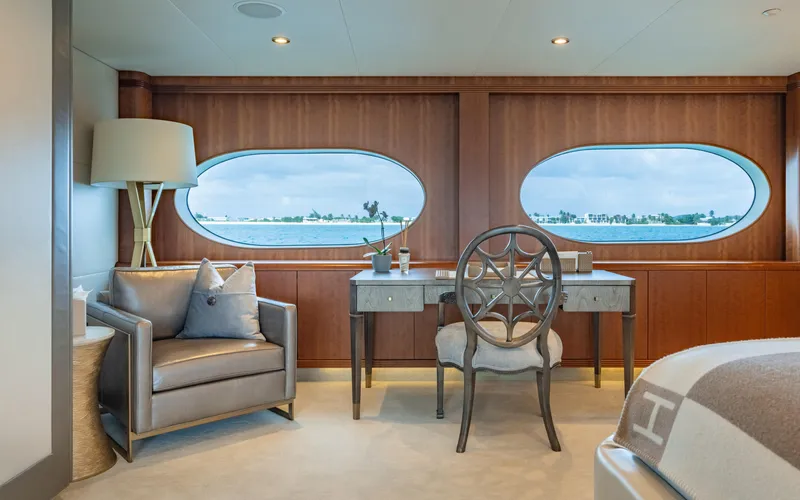 Sea Class Yacht Photos Pics Luxurious yacht interior with elegant desk, chair, and armchair, featuring ocean view windows. Christensen 1997.