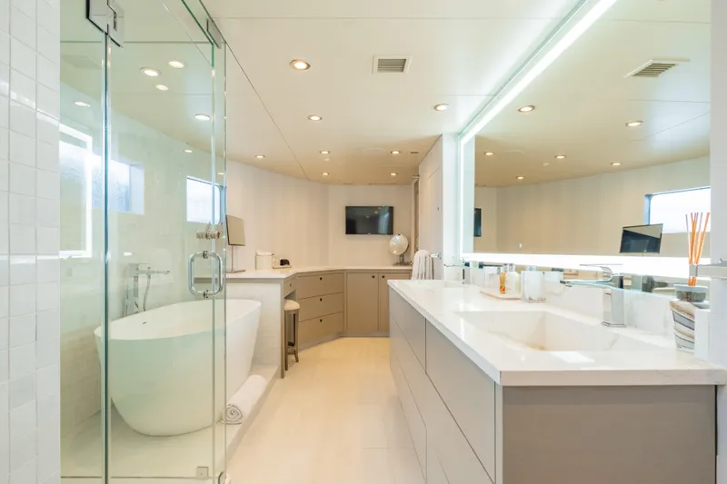 Sea Class Yacht Photos Pics Luxurious yacht bathroom with modern fixtures, glass shower, and large mirror, Christensen 1997 model.