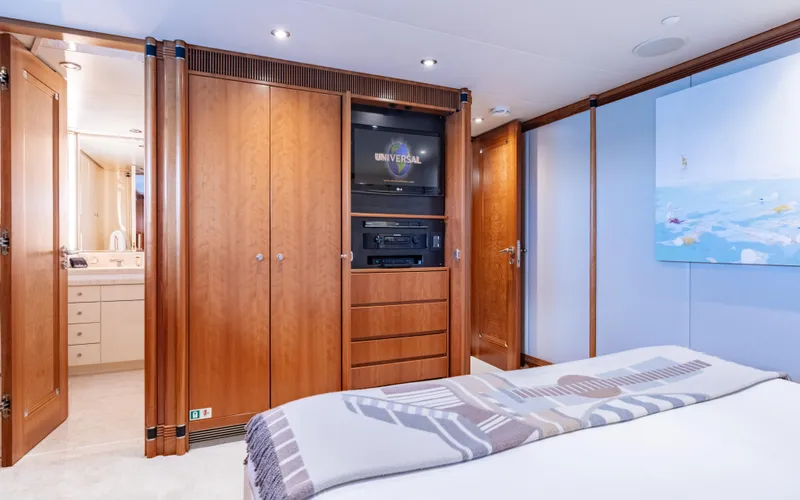 Sea Class Yacht Photos Pics Luxurious yacht bedroom with wooden cabinetry, TV, and ensuite bathroom, Christensen 1997 model.