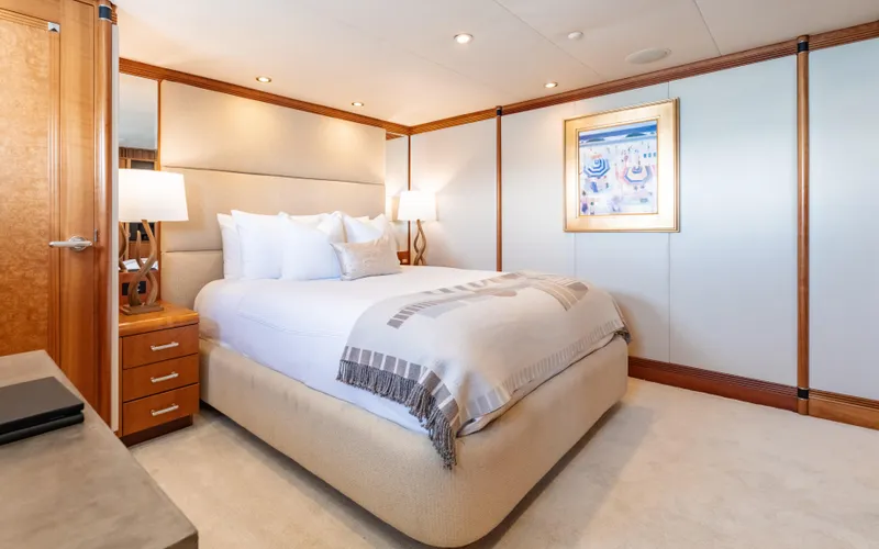 Sea Class Yacht Photos Pics Luxurious yacht bedroom with elegant decor, soft lighting, and framed artwork, Christensen 1997 model.