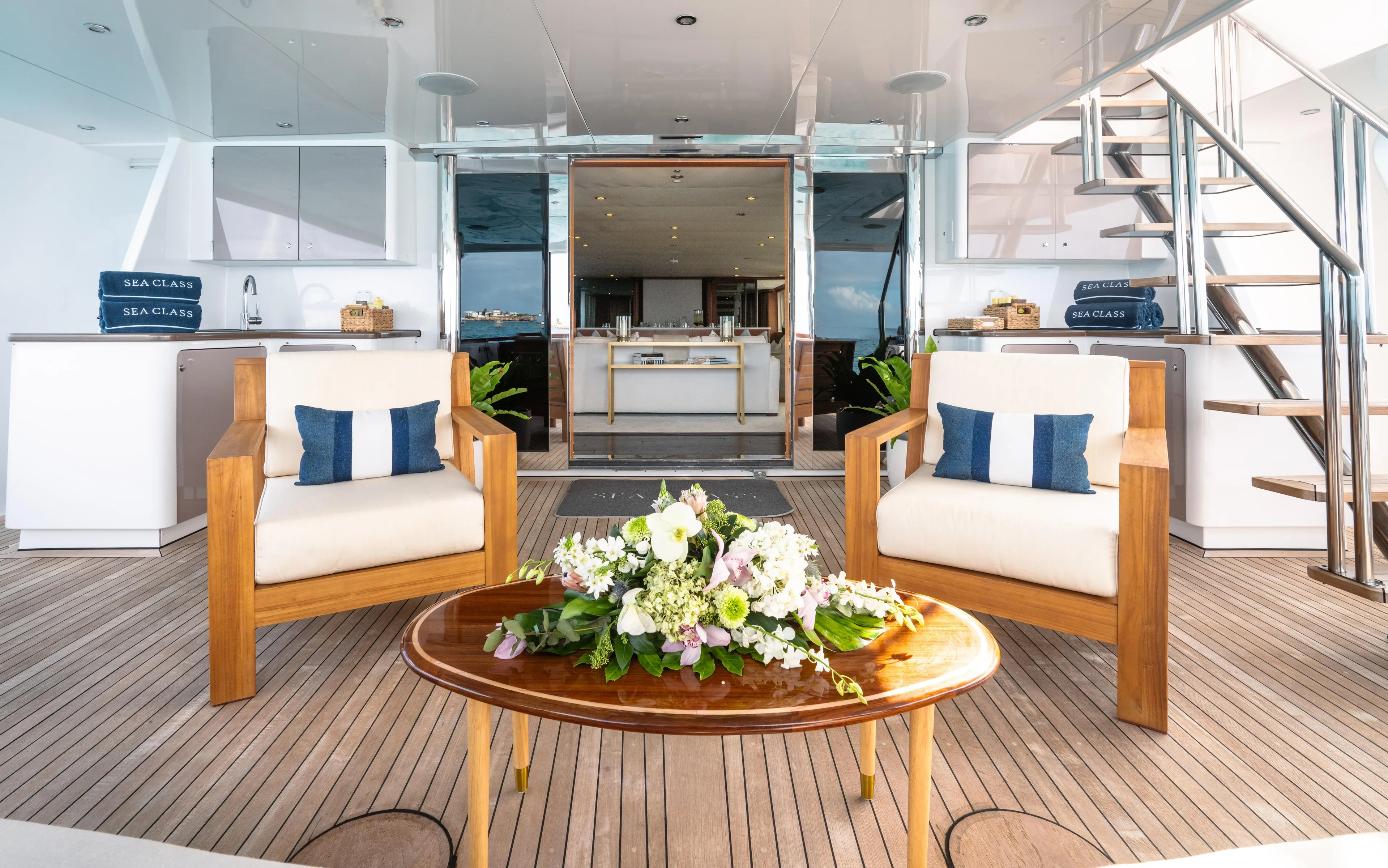 Sea Class Yacht Photos Pics Luxurious yacht interior with wooden furniture, floral centerpiece, and modern design, Christensen 1997 model.