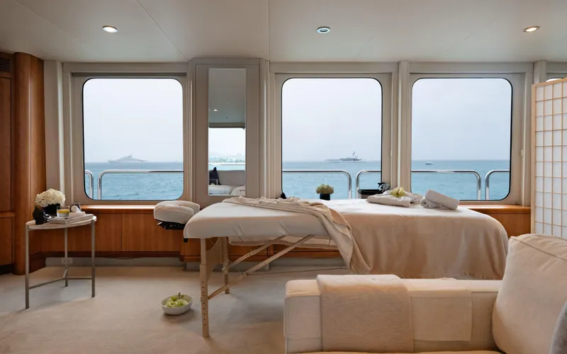 Sea Class Yacht Photos Pics Luxurious yacht interior with massage table, ocean view, and elegant decor. Christensen 1997 model.