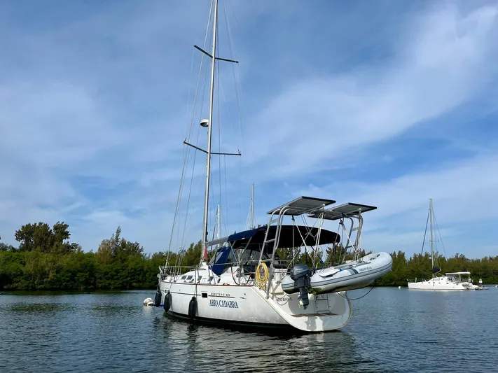Abra Cadabra Yacht Photos Pics 2004 Beneteau Oceanis 423 sailboat anchored on calm water under a clear blue sky.