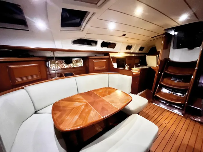 Abra Cadabra Yacht Photos Pics Luxurious interior of 2004 Beneteau Oceanis 423 sailboat with elegant wood finish and cozy seating.