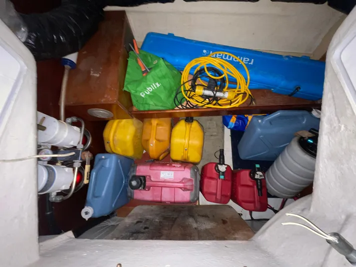 Abra Cadabra Yacht Photos Pics Storage area in a 2004 Beneteau Oceanis 423 sailboat with fuel containers and equipment.