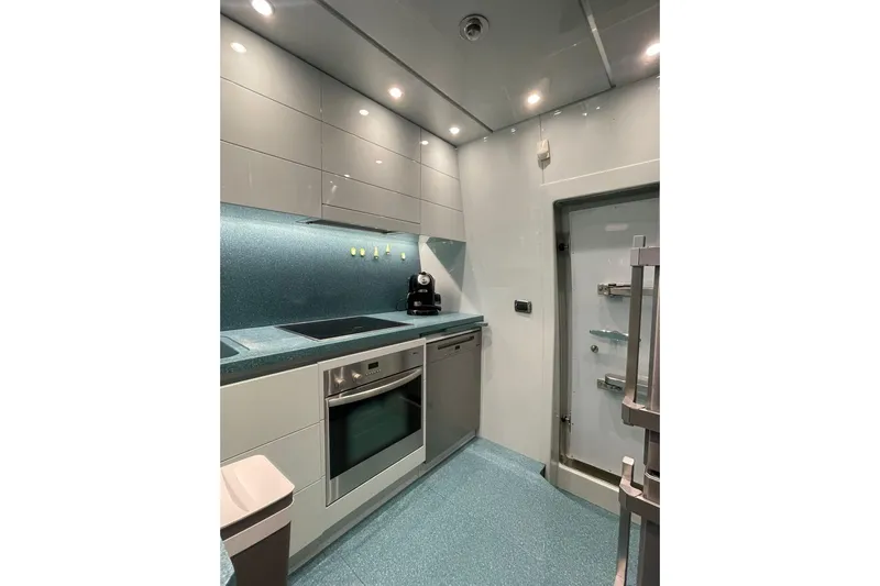  Yacht Photos Pics Modern kitchen interior in a 2004 Maiora 24 S yacht, featuring sleek cabinetry and appliances.