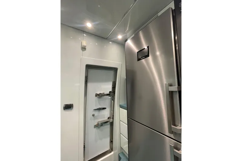  Yacht Photos Pics Modern kitchen area in a 2004 Maiora 24 S yacht with stainless steel appliances.