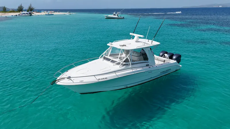  Yacht Photos Pics 2009 Hydra-Sports 3500 VX boat anchored in clear turquoise water near a sandy beach.