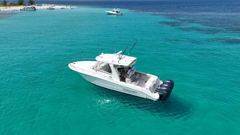  Yacht Photos Pics 2009 Hydra-Sports 3500 VX boat on clear turquoise water near a sandy beach.