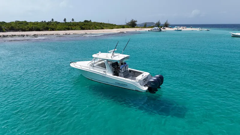  Yacht Photos Pics 2009 Hydra-Sports 3500 VX boat anchored in clear turquoise waters near a sandy beach.
