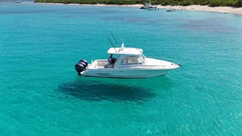  Yacht Photos Pics 2009 Hydra-Sports 3500 VX boat on clear turquoise water near a sandy beach.