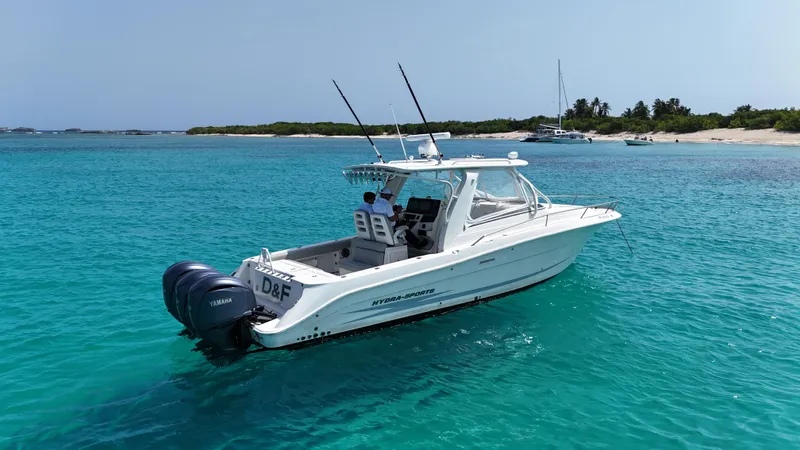  Yacht Photos Pics 2009 Hydra-Sports 3500 VX boat cruising in clear turquoise waters near a sandy beach.