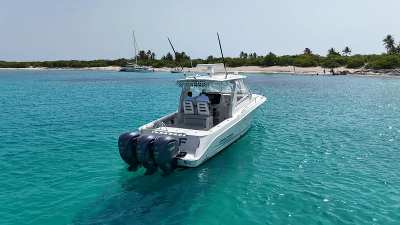  Yacht Photos Pics 2009 Hydra-Sports 3500 VX boat cruising in clear turquoise waters near a sandy beach.