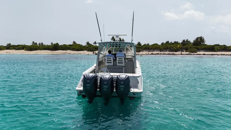  Yacht Photos Pics 2009 Hydra-Sports 3500 VX boat with triple engines on turquoise water near a sandy beach.