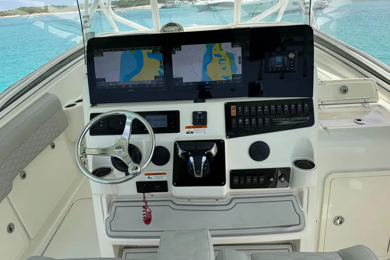  Yacht Photos Pics 2009 Hydra-Sports 3500 VX boat dashboard with navigation screens and steering wheel.