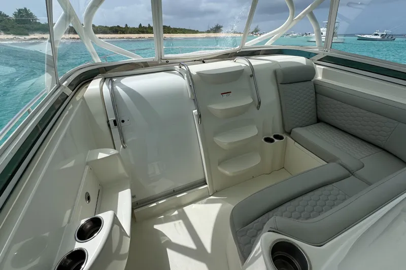  Yacht Photos Pics 2009 Hydra-Sports 3500 VX boat interior with seating and cup holders, near a tropical shoreline.