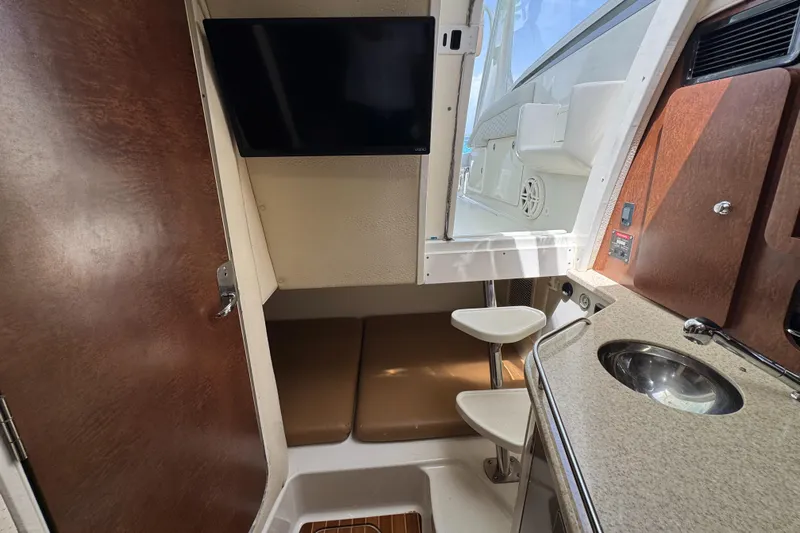  Yacht Photos Pics 2009 Hydra-Sports 3500 VX cabin interior with TV, seating, and kitchenette.