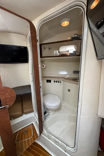  Yacht Photos Pics 2009 Hydra-Sports 3500 VX boat interior with compact bathroom and seating area.